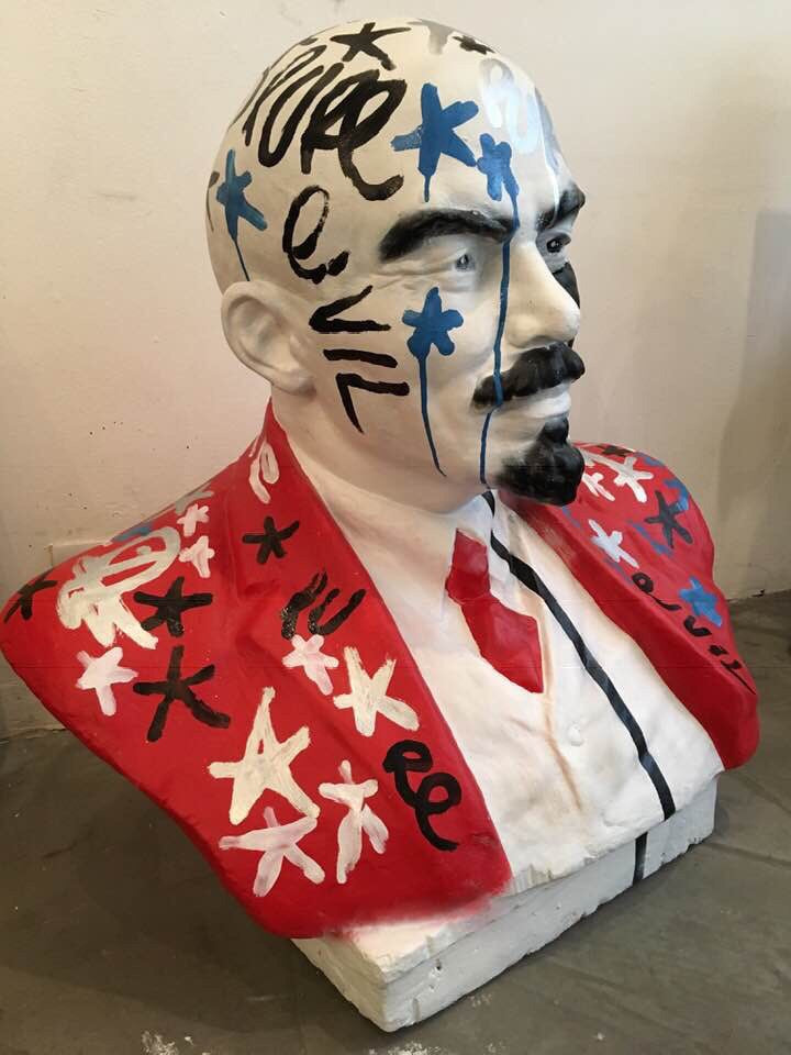 Defaced Lenin on white Plinth